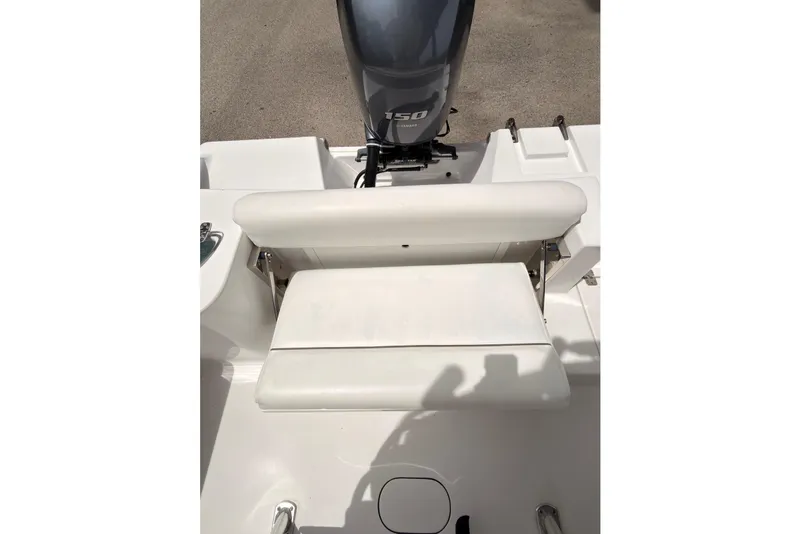 Slide: The Image of 2015 Sportsman Open 212 Center Console boat with Yamaha 150 engine, featuring white seating. - 13