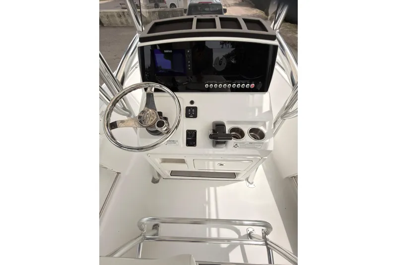 Slide: The Image of 2015 Sportsman Open 212 Center Console boat dashboard with steering wheel and controls. - 14