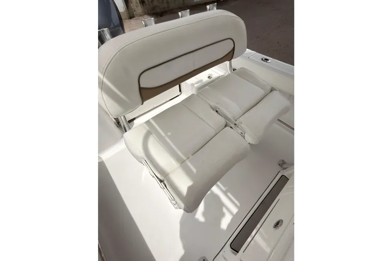 Slide: The Image of 2015 Sportsman Open 212 Center Console boat seat, white upholstery, comfortable design. - 15