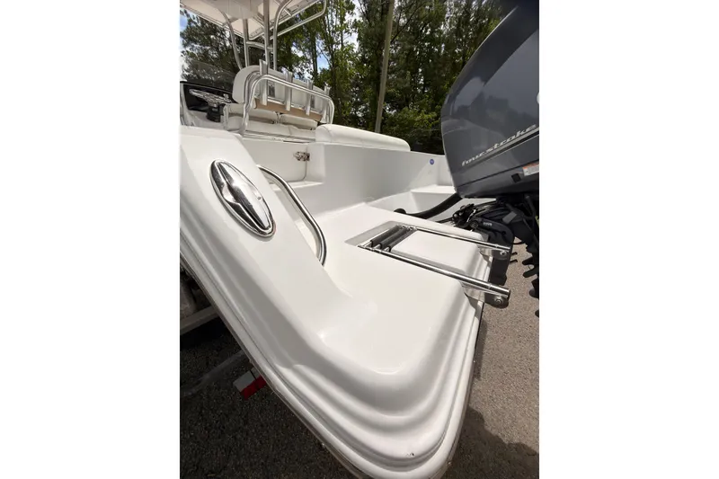 Slide: The Image of 2015 Sportsman Open 212 Center Console boat with ladder and outboard motor. - 19