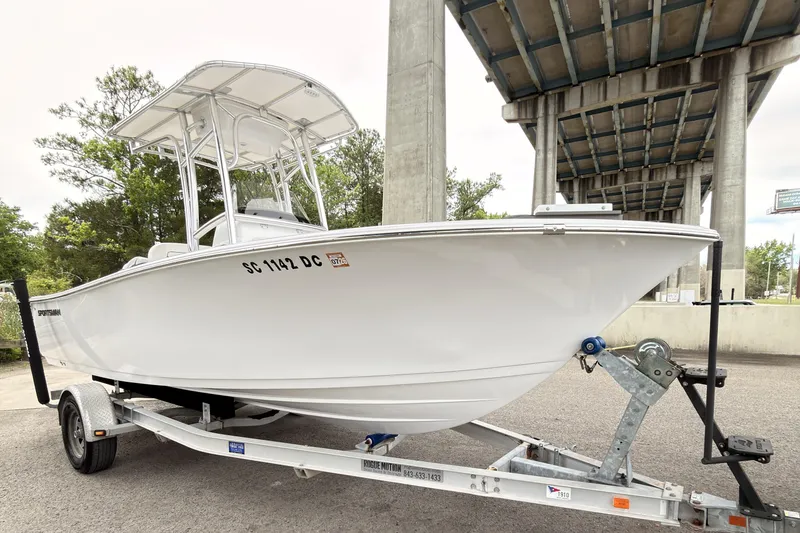 Slide: The Image of 2015 Sportsman Open 212 Center Console boat on trailer under bridge. - 2