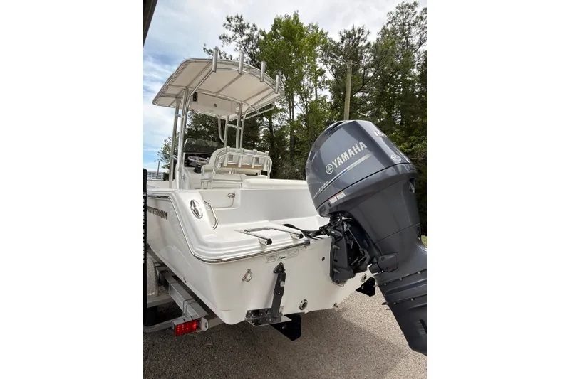 Slide: The Image of 2015 Sportsman Open 212 Center Console boat with Yamaha outboard motor, parked outdoors. - 22
