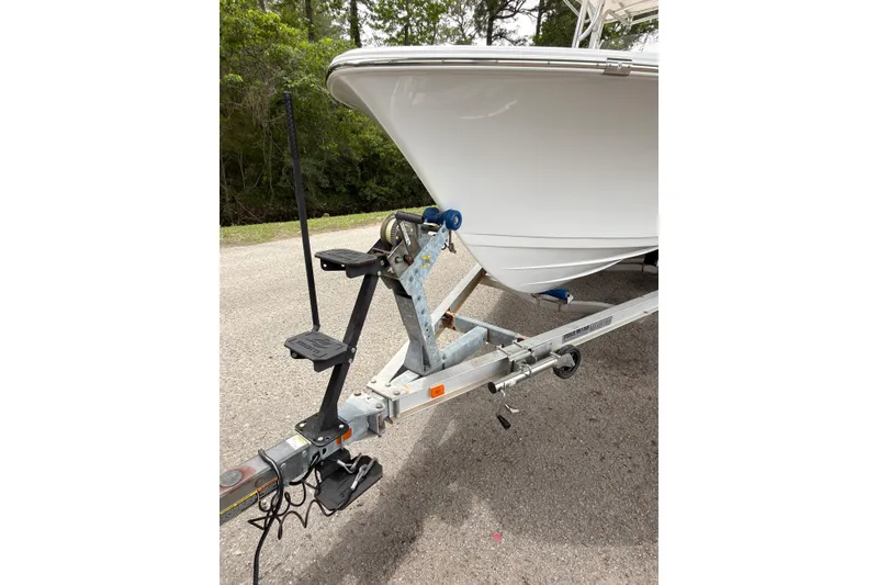 Slide: The Image of 2015 Sportsman Open 212 Center Console boat on trailer, parked on a road. - 24