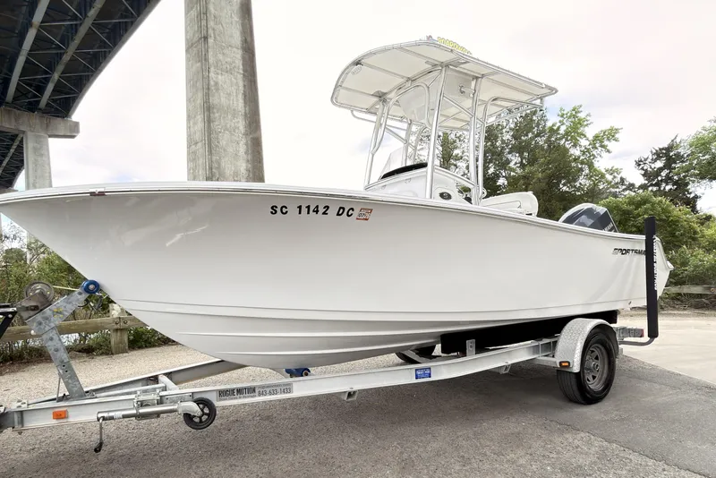 Slide: The Image of 2015 Sportsman Open 212 Center Console boat on trailer under bridge. - 5