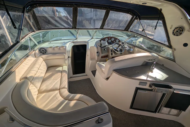 Slide: The Image of Interior of 2003 Rinker Fiesta Vee 342 boat with plush seating and modern dashboard. - 13