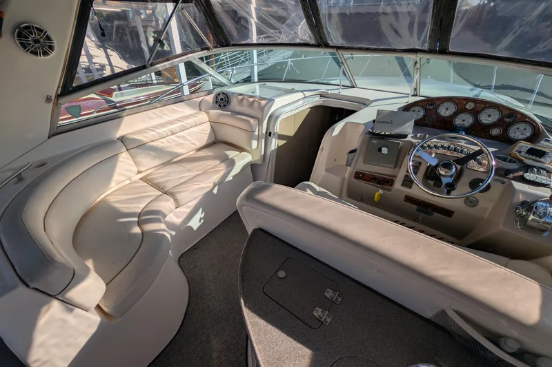 Slide: The Image of Interior of 2003 Rinker Fiesta Vee 342 boat with steering wheel and seating area. - 14