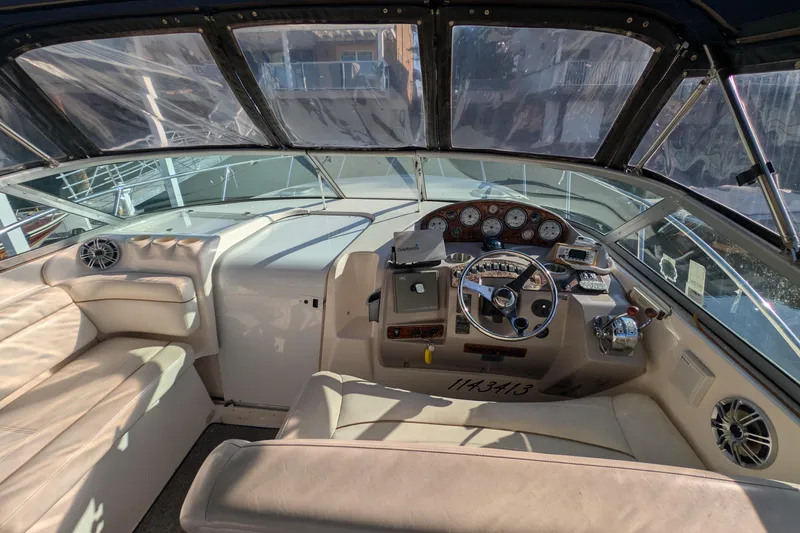 Slide: The Image of 2003 Rinker Fiesta Vee 342 boat interior with steering wheel and dashboard controls. - 15