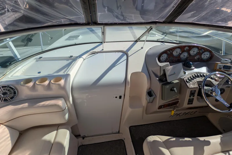 Slide: The Image of 2003 Rinker Fiesta Vee 342 boat cockpit with steering wheel and instrument panel. - 16
