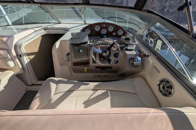 Slide: The Image of 2003 Rinker Fiesta Vee 342 boat cockpit with steering wheel and navigation instruments. - 18