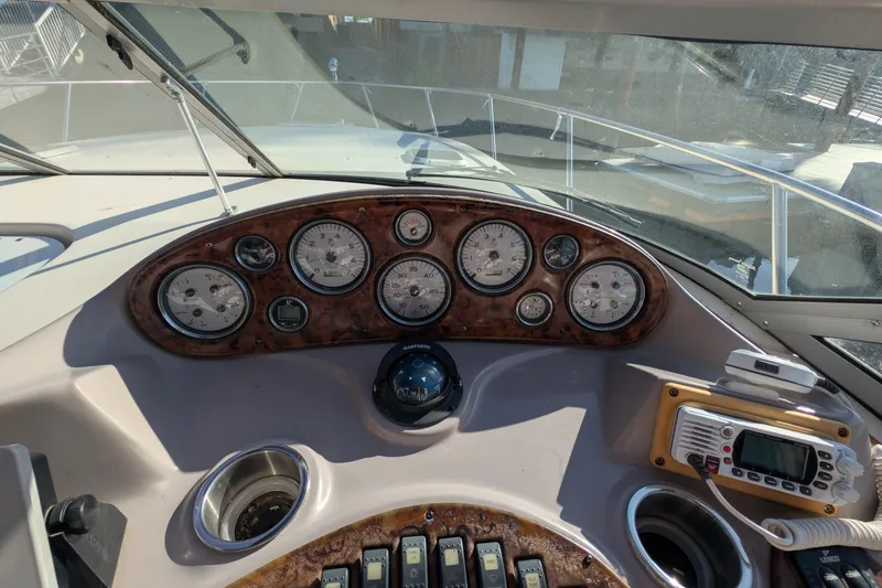 Slide: The Image of 2003 Rinker Fiesta Vee 342 dashboard with gauges and navigation equipment. - 19