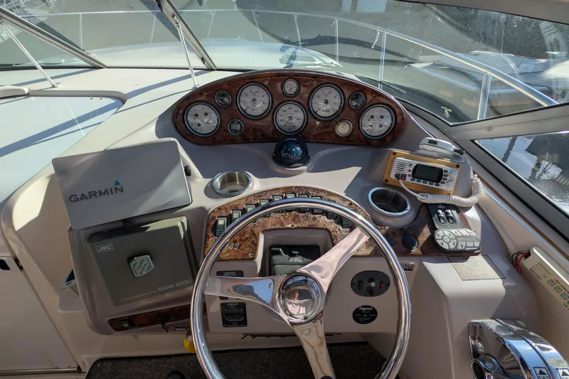 Slide: The Image of 2003 Rinker Fiesta Vee 342 boat dashboard with Garmin navigation and control instruments. - 20