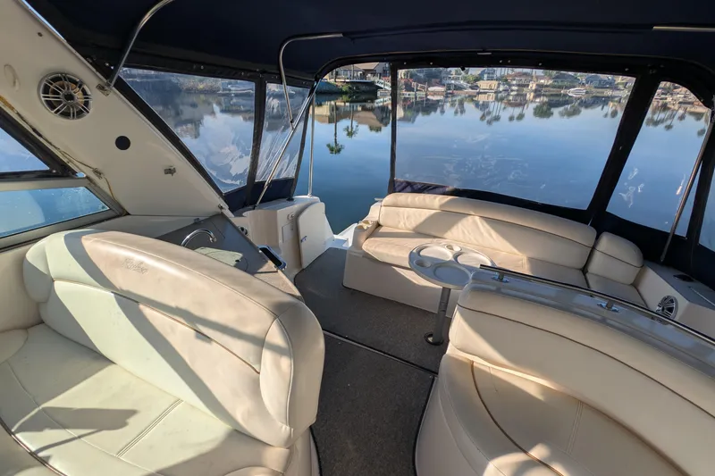 Slide: The Image of Interior of 2003 Rinker Fiesta Vee 342 boat with beige seating and lake view. - 23