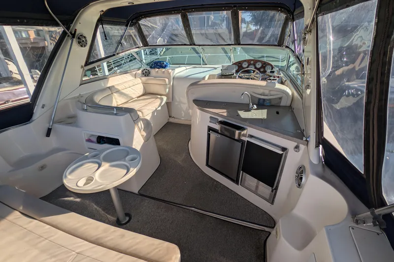 Slide: The Image of 2003 Rinker Fiesta Vee 342 yacht interior with seating, kitchenette, and helm. - 25