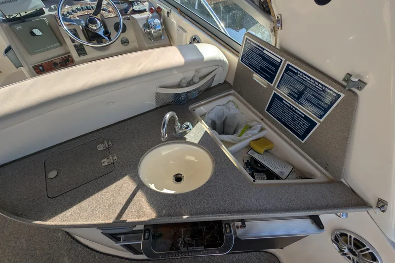 Slide: The Image of 2003 Rinker Fiesta Vee 342 boat interior with sink and control panel. - 27