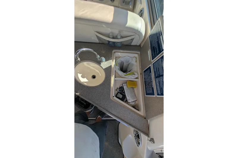 Slide: The Image of 2003 Rinker Fiesta Vee 342 boat interior with sink and storage compartment. - 29