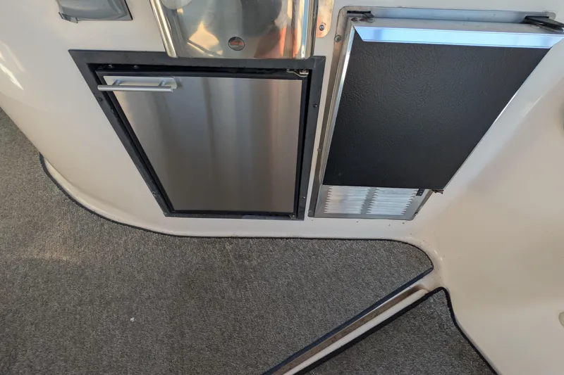 Slide: The Image of 2003 Rinker Fiesta Vee 342 interior with stainless steel fridge and carpeted flooring. - 31
