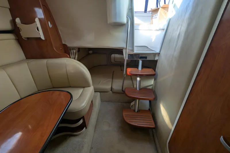 Slide: The Image of Interior of 2003 Rinker Fiesta Vee 342 boat with wooden steps and seating area. - 32