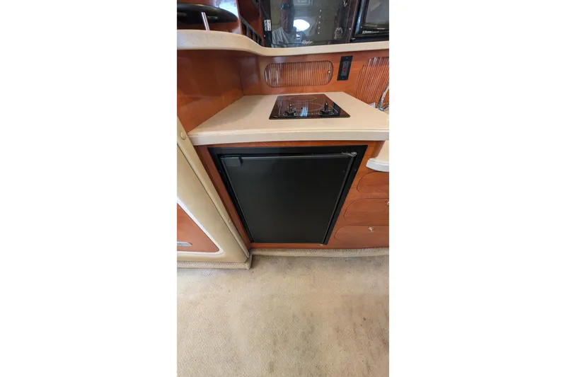 Slide: The Image of 2003 Rinker Fiesta Vee 342 yacht kitchen with stove and compact refrigerator. - 36