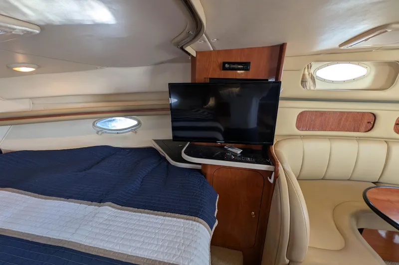 Slide: The Image of Interior of 2003 Rinker Fiesta Vee 342 yacht with bed, TV, and seating area. - 38