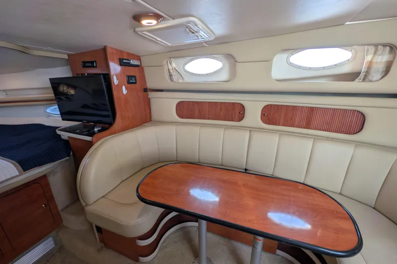 Slide: The Image of Interior of 2003 Rinker Fiesta Vee 342 yacht with cozy seating and wooden table. - 40