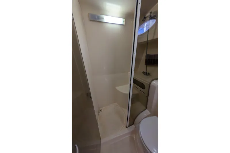Slide: The Image of Bathroom interior of 2003 Rinker Fiesta Vee 342 boat, featuring shower and toilet. - 44