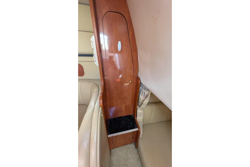 Slide: The Image of Interior of 2003 Rinker Fiesta Vee 342, featuring wood paneling and seating area. - 46