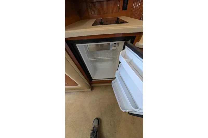 Slide: The Image of Open mini fridge in 2003 Rinker Fiesta Vee 342 boat kitchen area. - 50