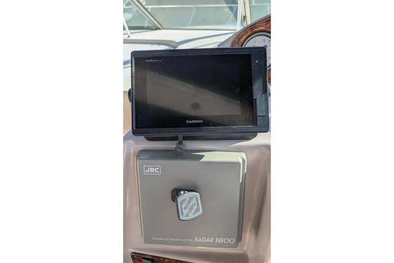 Slide: The Image of Garmin GPS and JRC Radar 1800 on 2003 Rinker Fiesta Vee 342 boat dashboard. - 56