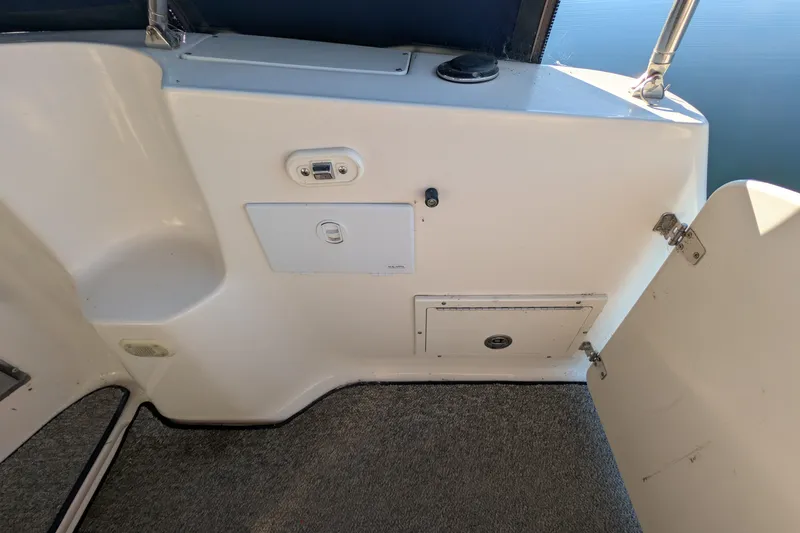 Slide: The Image of 2003 Rinker Fiesta Vee 342 boat interior with storage compartments and carpeted flooring. - 57