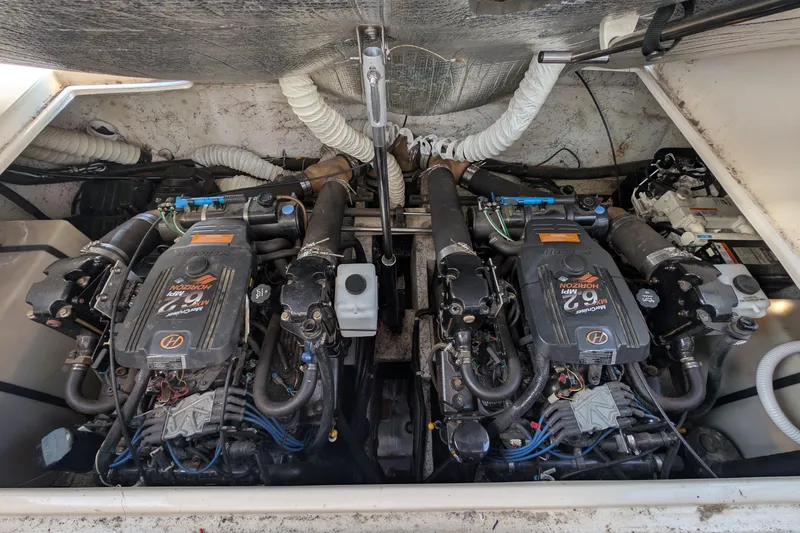 Slide: The Image of Engine compartment of a 2003 Rinker Fiesta Vee 342 boat, featuring dual MerCruiser engines. - 60