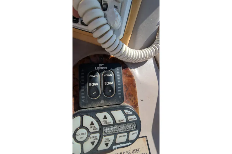 Slide: The Image of Control panel of a 2003 Rinker Fiesta Vee 342 boat with Lenco trim tab switches. - 69