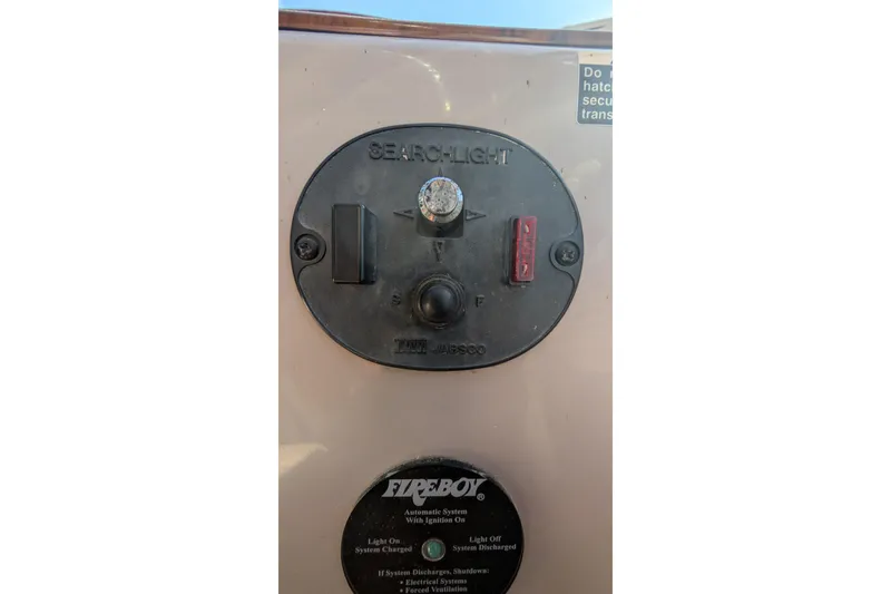 Slide: The Image of Control panel of a 2003 Rinker Fiesta Vee 342 boat, featuring searchlight and Fireboy system. - 70