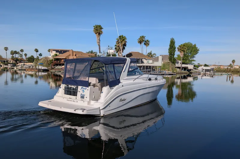 Slide: The Image of 2003 Rinker Fiesta Vee 342 boat cruising on a calm lake with palm trees. - 73