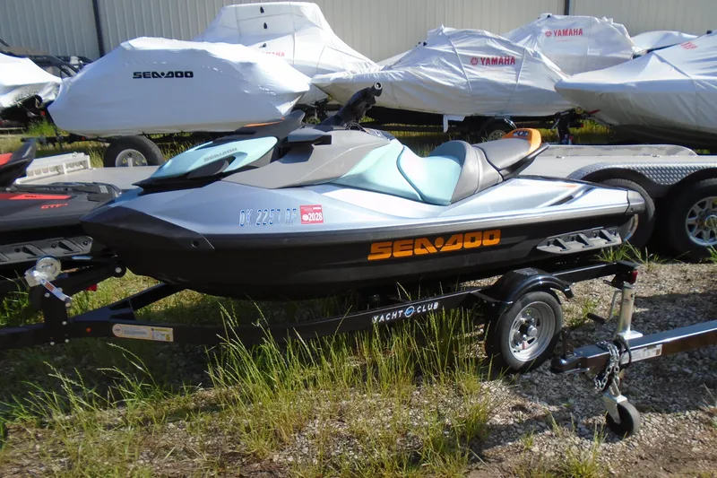 The Image of 2023 Sea-Doo GTI SE 130 jet ski on trailer, parked outdoors. - 1
