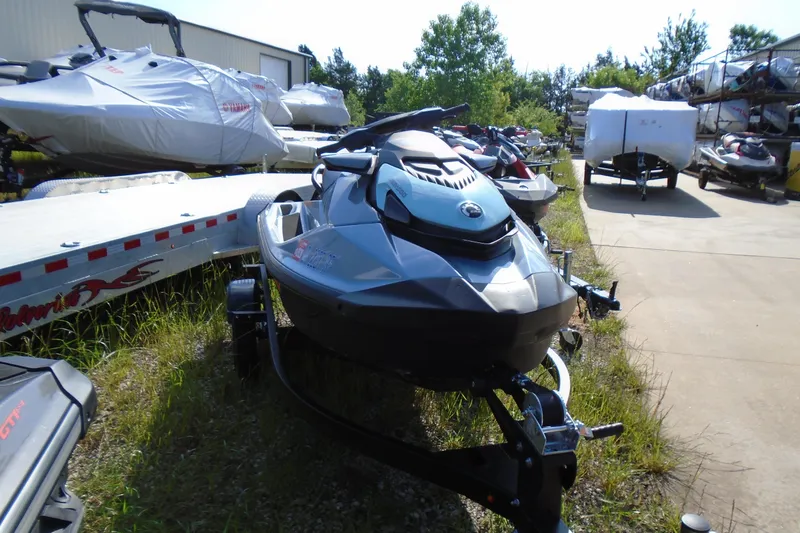 Slide: The Image of 2023 Sea-Doo GTI SE 130 jet ski on trailer, parked outdoors. - 3