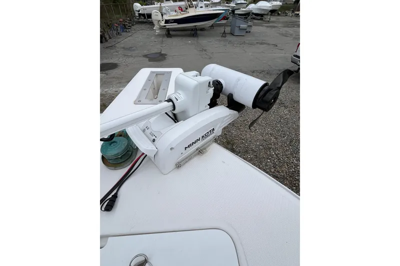 Slide: The Image of 2005 Angler 2700CC boat with Minn Kota trolling motor in a marina setting. - 10