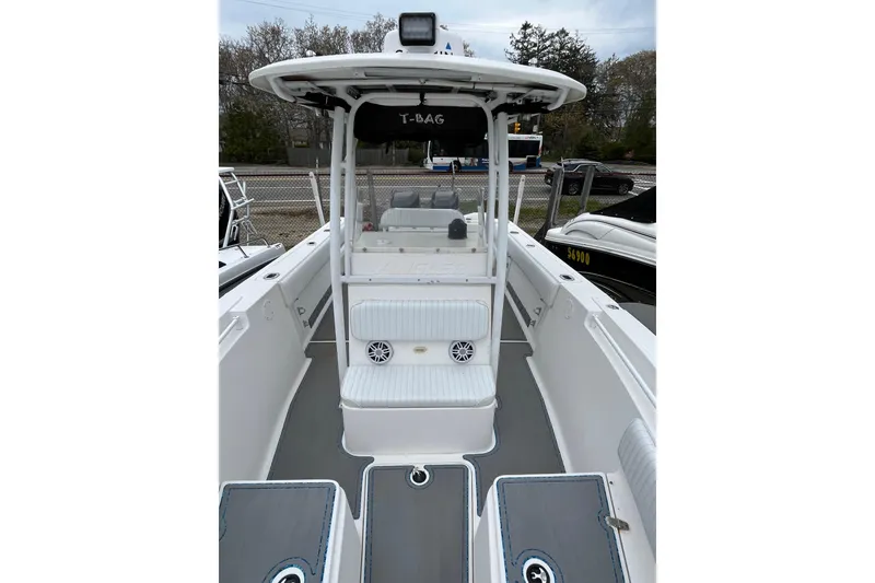 Slide: The Image of 2005 Angler 2700CC boat interior with seating and storage compartments. - 12