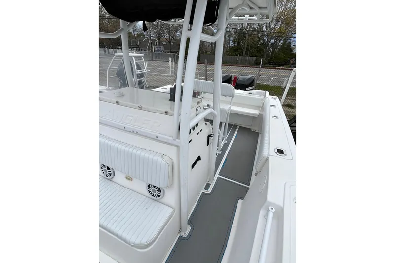 Slide: The Image of 2005 Angler 2700CC boat interior with seating and console, showcasing spacious design. - 14