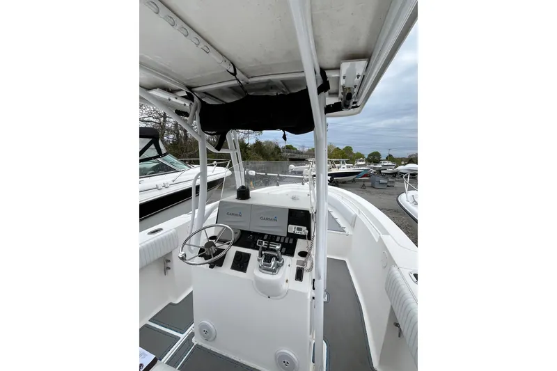 Slide: The Image of 2005 Angler 2700CC boat cockpit with steering wheel and Garmin navigation system. - 15