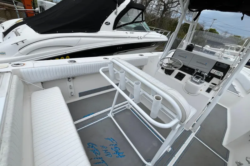 Slide: The Image of 2005 Angler 2700CC boat interior with steering console and rod holders. - 16