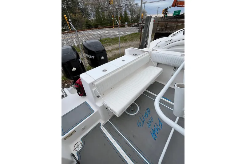 Slide: The Image of 2005 Angler 2700CC boat interior with seating and dual Mercury engines. - 18