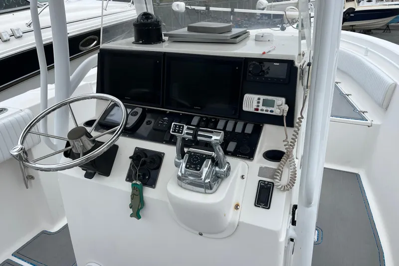 Slide: The Image of 2005 Angler 2700CC boat dashboard with steering wheel, controls, and navigation equipment. - 20