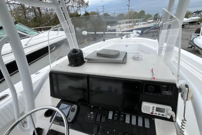 Slide: The Image of 2005 Angler 2700CC boat dashboard with navigation equipment and controls. - 21