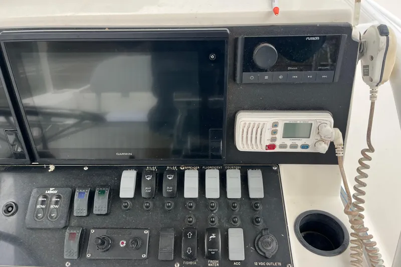 Slide: The Image of Control panel of a 2005 Angler 2700CC boat with Garmin and Fusion electronics. - 22