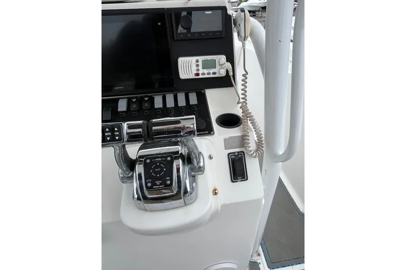 Slide: The Image of Center console of a 2005 Angler 2700CC boat with navigation controls and radio. - 24