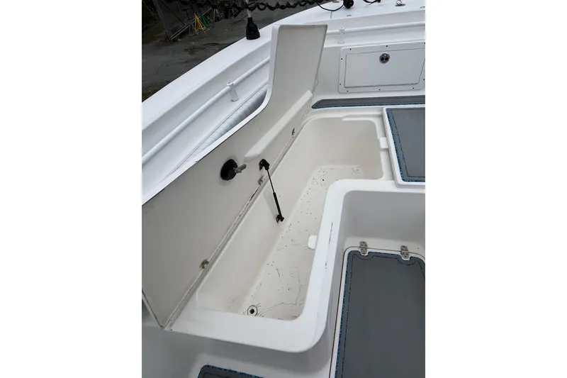 Slide: The Image of Open storage compartment on a 2005 Angler 2700CC boat deck. - 26