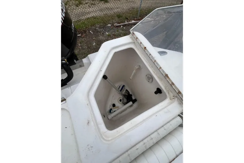 Slide: The Image of Open storage compartment on a 2005 Angler 2700CC boat, showing interior details. - 28