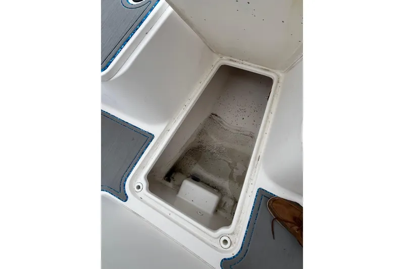 Slide: The Image of Open storage compartment on 2005 Angler 2700CC boat deck, showing interior details. - 29