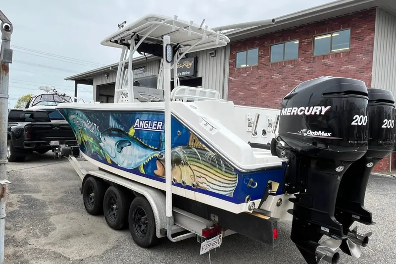 Slide: The Image of 2005 Angler 2700CC boat with vibrant marine graphics and twin Mercury 200 engines. - 3
