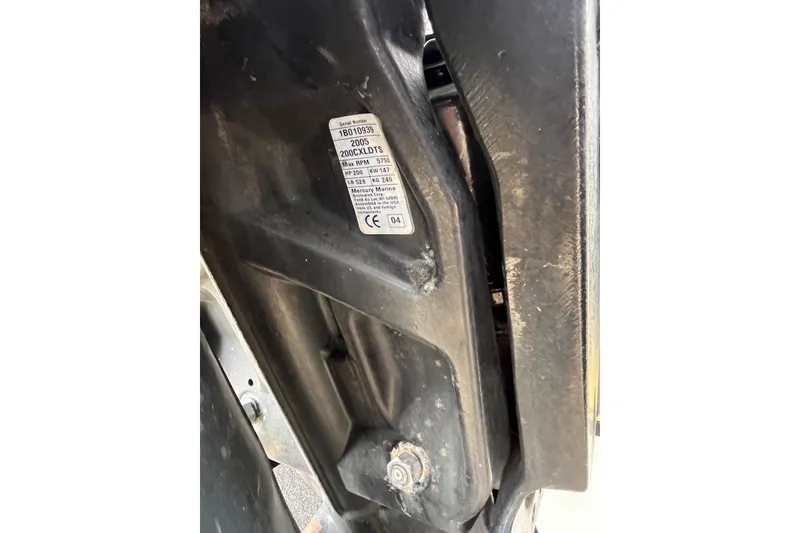Slide: The Image of Close-up of a 2005 Angler 2700CC boat engine with visible serial number label. - 35